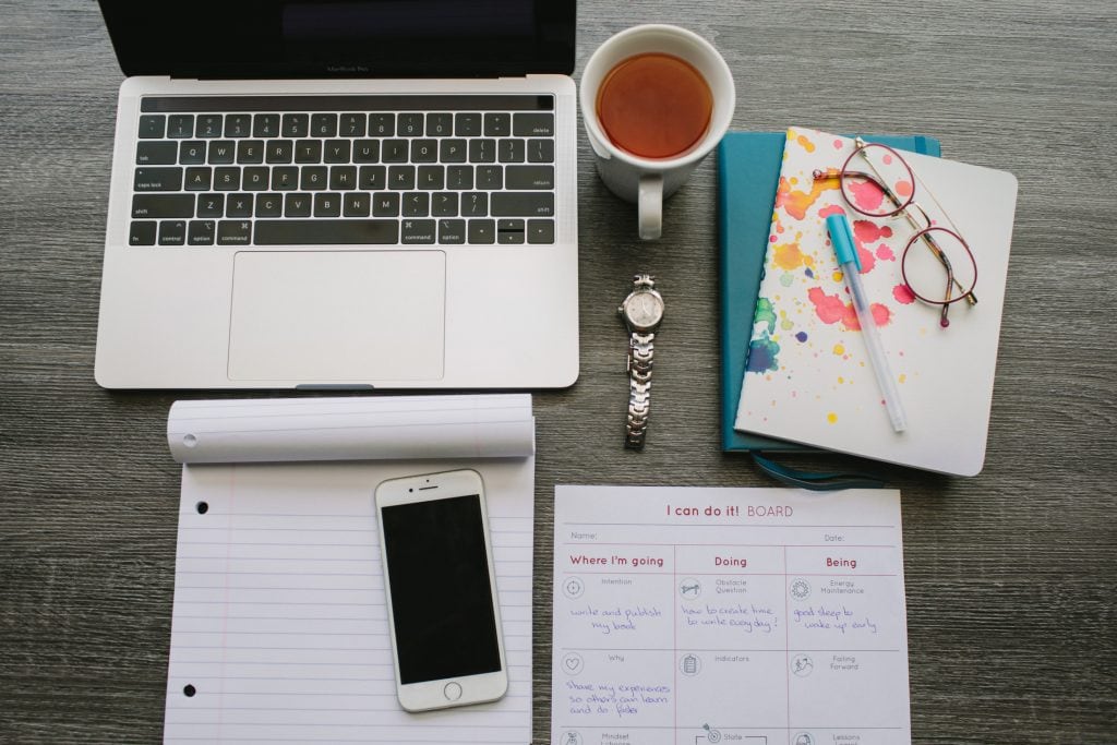 Flatlay of laptop and notepads in Vancouver BC