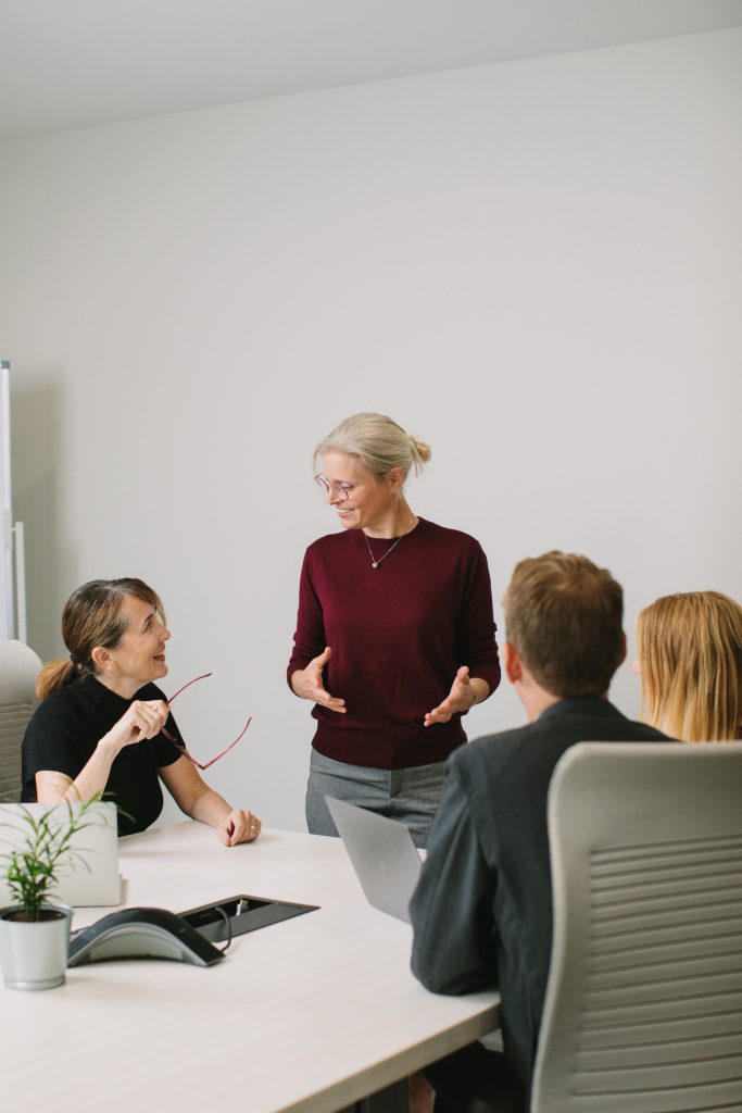 Business coach presenting in boardroom during personal brand session